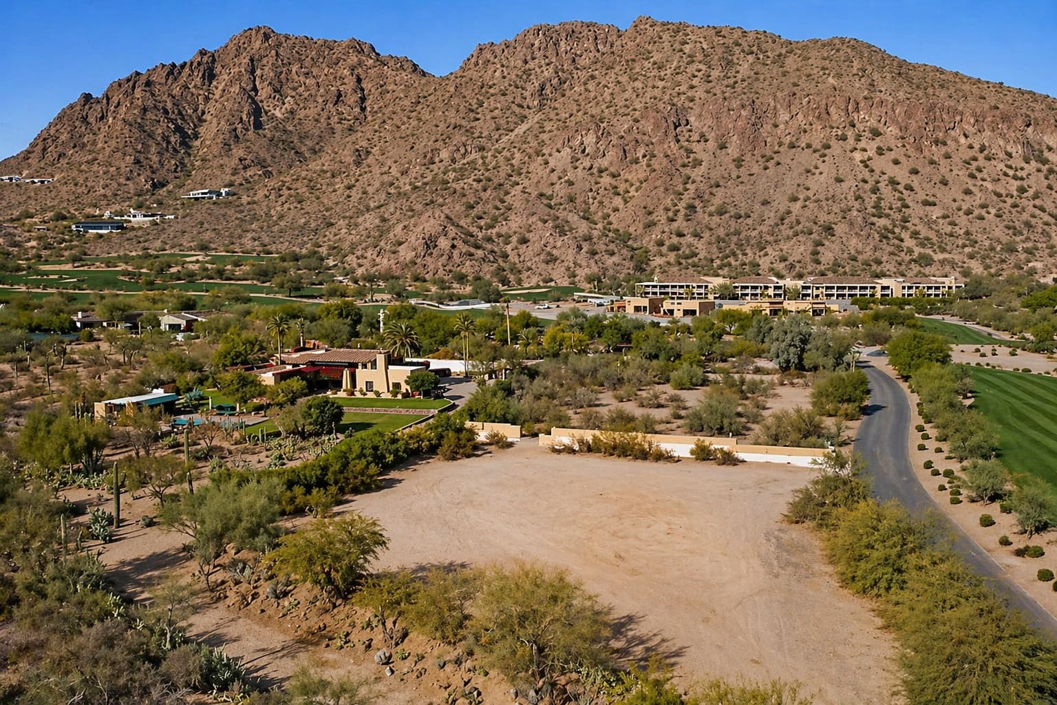 Hillside parcel at the base of a desert mountain with open Sonoran terrain in the foreground.